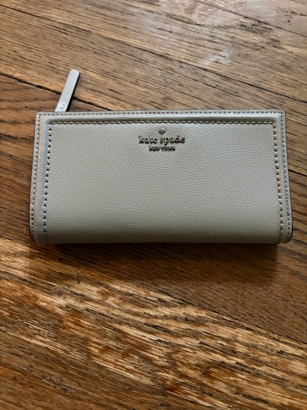 kate spade pebble leather zip-around wallet in light gray